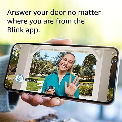 Person using a smartphone to view a visitor through a doorbell camera app.