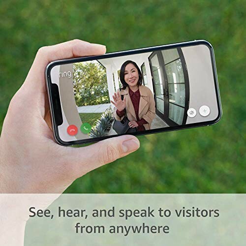 Person holding smartphone showing video call with visitor at door